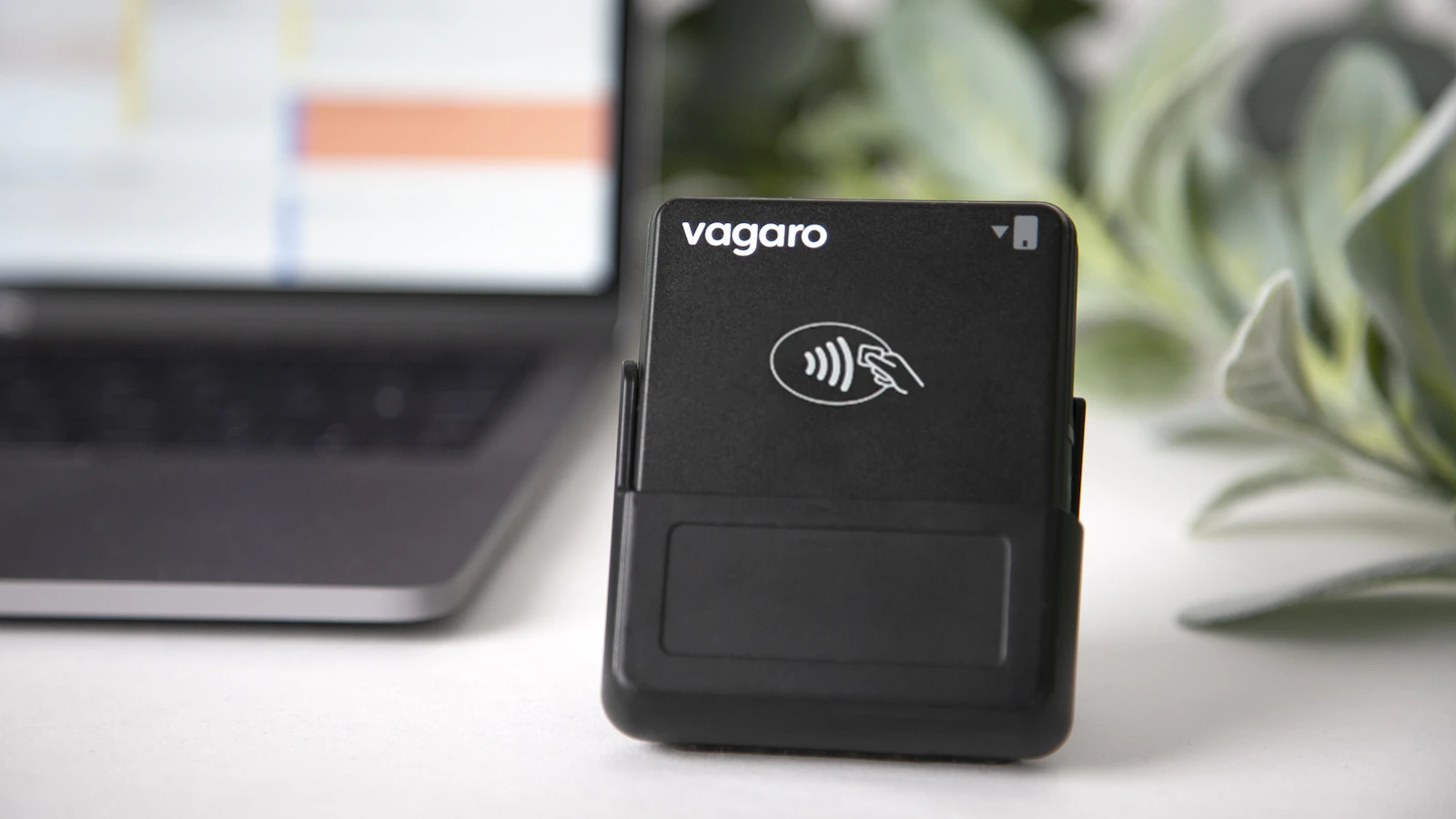 A card payment reader next to a laptop