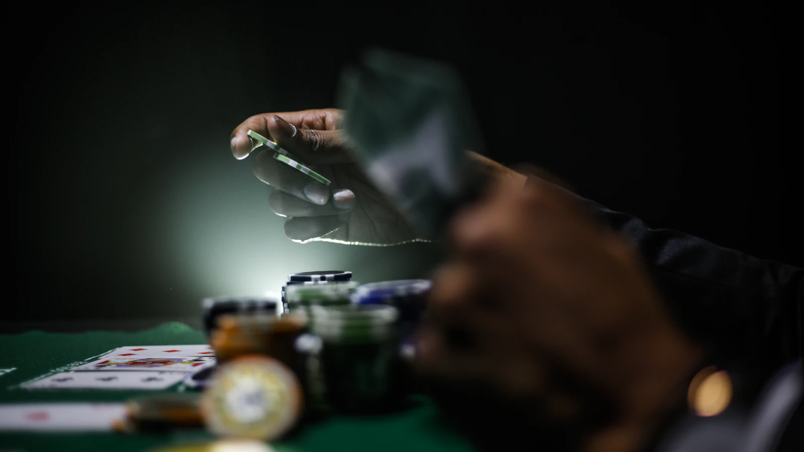 Poker chips and playing cards on a gaming table