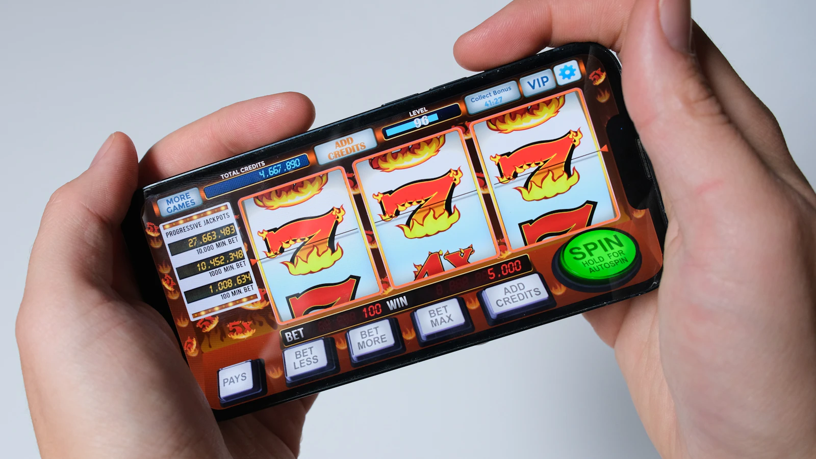 A player using a colorful mobile game on a smartphone
