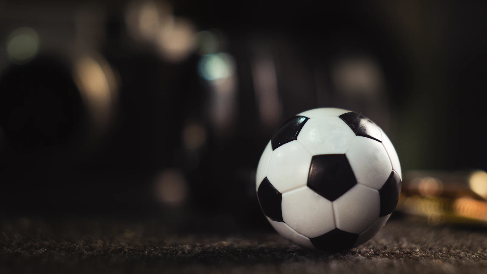 A football resting on a grass pitch